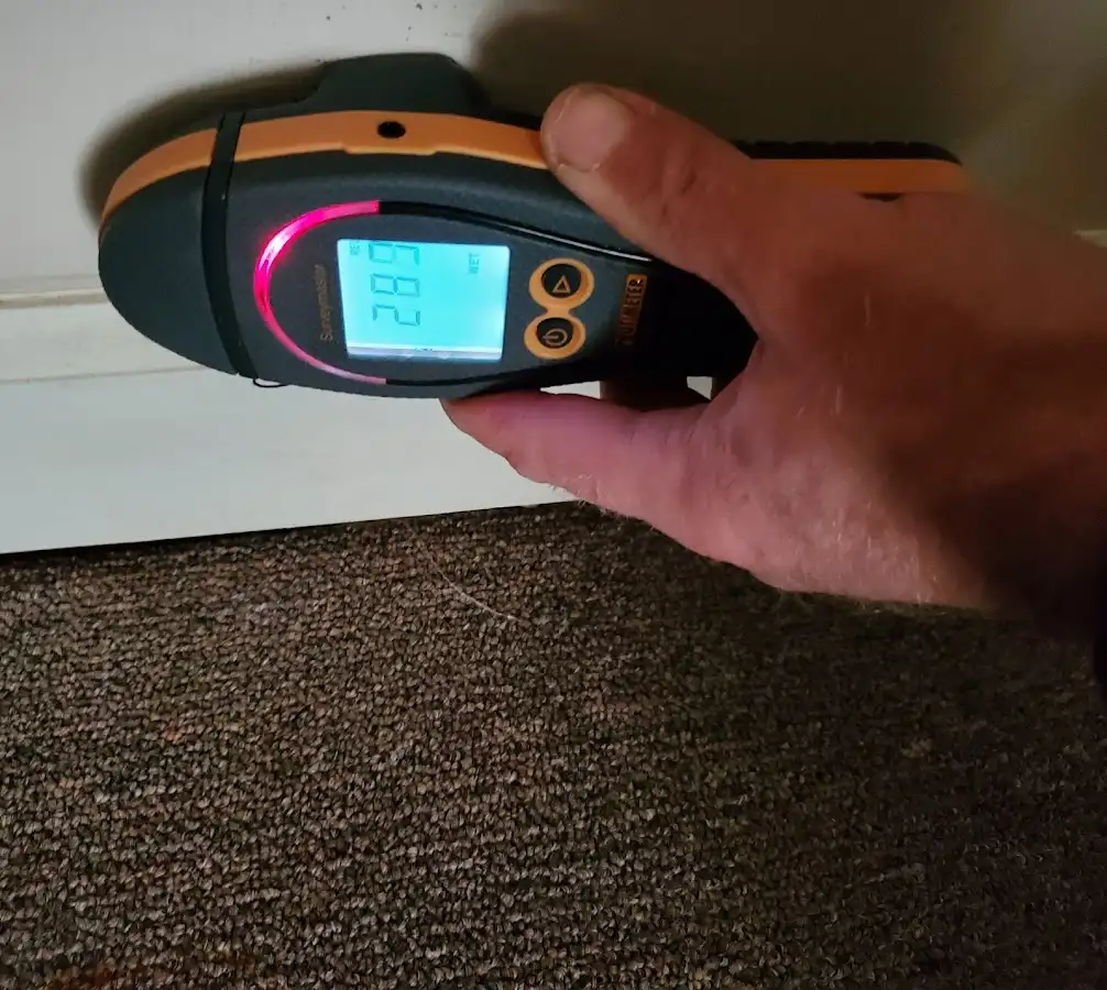 Moisture detection at baseboard during Storm Damage Restoration in Marshall
